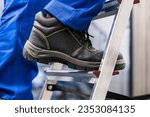 Small photo of Low Section View Of A Handyman's Foot Climbing Ladder