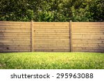 Wooden fence on a green lawn