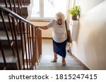 Senior Woman Climbing Staircase ...