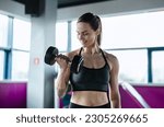 Young woman exercising with...