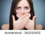 Woman covering mouth
