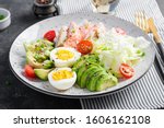 Ketogenic diet, breakfast. Eggs, fish and avocado, lettuce and seeds. Low carb high fat breakfast. Keto/paleo menu.