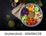 Healthy salad with chicken, tomatoes,  cucumber, lettuce, carrot, celery, red cabbage and  mung bean on dark background. Proper nutrition. Dietary menu. Flat lay. Top view