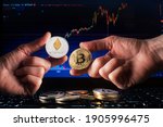 Business men holding bitcoin and ethereum coin whit computer trading chart background. Bitcoin and altcoin the most important cryptocurrency concept