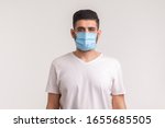Protection against contagious disease, coronavirus, covid-19. Man wearing hygienic mask to prevent infection, airborne respiratory illness such as flu, 2019-nCoV. indoor isolated on white background