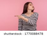 Small photo of Get out! Portrait of vexed angry woman in striped sweatshirt grimacing madly and ordering to go away, feeling betrayed resentful, break up concept. indoor studio shot isolated on pink background