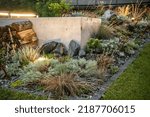 Small photo of LED Illuminated Residential Backyard Rockery Garden Close Up. Gardening and Landscaping Industry Theme.