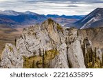 Small photo of Two tiny hikers in grandeur of Sapper Hill wilderness landscape near Dempster Highway in Ogilvie Mountains of Yukon Territory, YT, Canada
