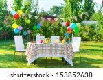 Prepared birthday table in summer green garden