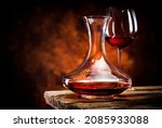 Small photo of Wine in a decanter and glass on a wooden table