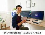 Portrait of a happy broker getting rich and earning a lot of money for selling or buying NFT art collections