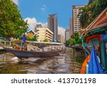 Boat transporting passengers and tourist down Chao Praya river , Bangkok , Thailand 