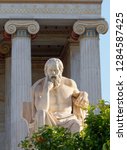 Small photo of Socrates the ancient greek philosopher in front af the national academy neoclassical building, Athens Greece