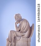 Small photo of Socrates the ancient Greek philosopher and thinker white marble statue under blue sky, Athens Greece