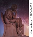 Small photo of Socrates the ancient Greek philosopher statue under dramatic night sky, Athens Greece