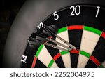 Small photo of Three darts in triple twenty on professional sisal steeldart. perfect 180 highscore shot dart game hobby sport concept background.