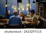 Small photo of A modern and traditional European Islamic family comes together for iftar in a contemporary restaurant during the Ramadan fasting period, embodying cultural harmony and familial unity amidst a