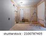 Small photo of Working process of installing gypsum walls from plasterboard -drywall - in apartment is under construction, remodeling, renovation, extension, restoration and reconstruction.