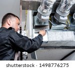 Ventilation cleaning. Specialist at work. Repair ventilation system (HVAC). Industrial background