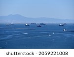 Small photo of Los Angeles, CA USA - July 16, 2021: Backlog of container ships waiting beyond the breakwater at sea to unload at the Port of Los Angeles and Long Beach