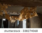 Small photo of Tattered eroded aged peel off fabric hang from kraft particle boards on plafond for remodel redecorate diy in dilapidated hut. Closeup view with space for text on backdrop of premises overhaul remount