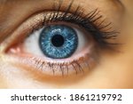 Female Blue Eye With Long Lashes Close Up. Human Eye Macro Detai