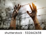 Refugee men and fence