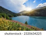 Beautiful view of the emerald alpine lake. Dramatic and picturesque scene. Mountain lake in the background of mountains and sky