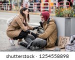 Young Woman Giving Money To...
