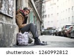 Homeless Beggar Man Sitting...