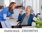 Small photo of Nurse with clown nose having fun with her senior woman client.