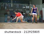 Small photo of AUGUST 19, 2014 - KUALA LUMPUR, MALAYSIA: Heba El Torky of Egypt (red) rushes forward to hit a return in her match against Low Wee Wern of Malaysia in the CIMB Malaysian Open Squash Championship 2014.