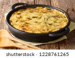 Healthy dietary English food Bubble & Squeak from baked mashed potatoes with cabbage and Brussels sprouts in a pan on the table. horizontal