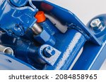 Small photo of close-up view on hydraulic valve and piston of blue floor car jack