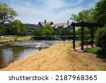 Small photo of Greenville, South Carolina USA - May 4, 2022: Downtown cityscape view of Falls Park on the Reedy in this charming southern town.