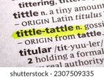 Small photo of close up photo of the words tittle tattle