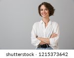 Image of happy young business woman posing isolated over grey wall background.