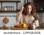 Photo of pretty caucasian woman holding cooking ladle spoon while eating soup with fresh vegetables in kitchen at home