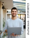 Small photo of White bristle man smiling and working with laptop at office indoors