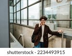 European brunette woman talking on cellphone and smiling at underpass