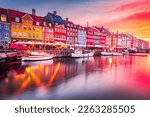 Copenhage, Denmark. Experience the breathtaking beauty of Nyhavn canal at sunrise, with its iconic colorful buildings and serene water reflections.