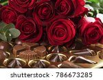 Small photo of Vibrant red roses on a box of chocolates for valentine's day, or any day to say I love you.