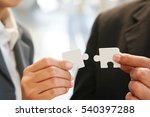 Small photo of Businessman and woman holding Incongruous connecting white piece jigsaw puzzle, Business connection, success and strategy concept.