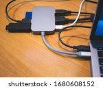 usb type-c hub connected to laptop with lot of cables connected for peripheral computer device equipment