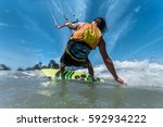 A Kite Surfer Rides The Waves