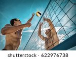 Beach Volleyball players in sunglasses under sunlight. Dynamic sport action near the net, outdoor.