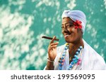 Portrait of african cuban woman smoking cohiba cigar and looking at camera smiling 