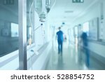 Silhouette of a doctor walking in a hurry in the hospital corridor.