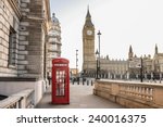 London - Big Ben tower and a red phone booth . Telephone box empty streets. Covid 19 Coronavirus lockdown