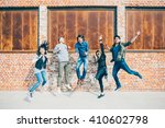 Group of young beautiful multiethnic man and woman friends having fun jumping outdoor in the city - happiness, friendship, teamwork concept 
